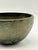 This vintage bronze bowl features a softly rounded form and a naturally developed, timeworn patina with earthy green and...