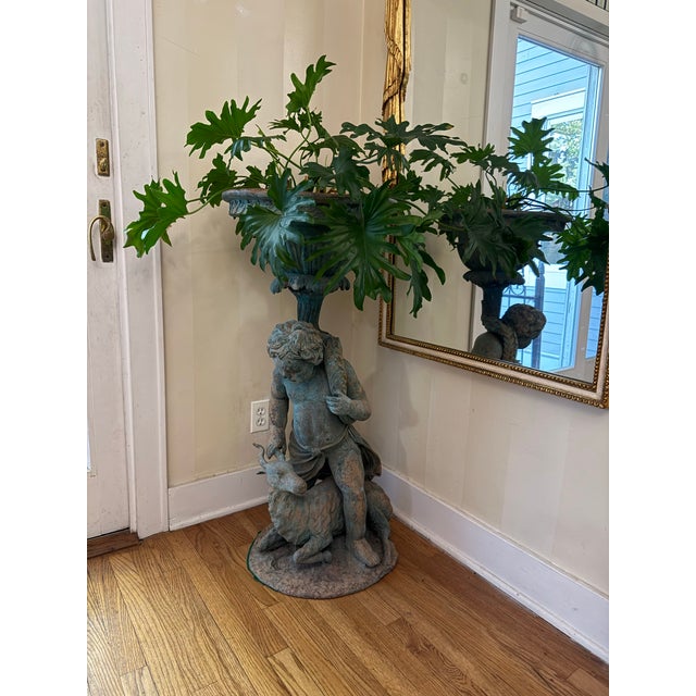 Antique 19th century bronze planter of a boy and goat that was once kept outdoors. I brought it inside because I loved...