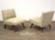 A pair of mid century modern slipper lounge chairs newly reupholstered in a light grey. Seat height is 18.5”. 25” wide....