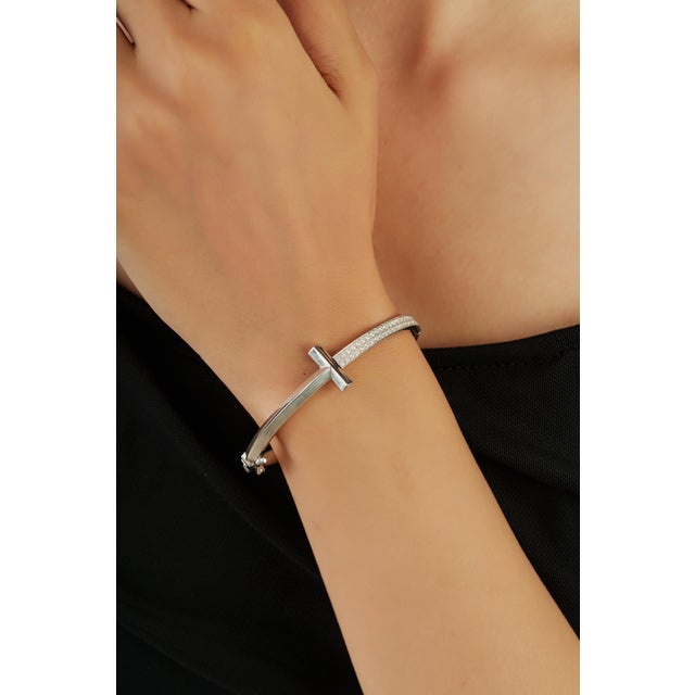 The 925 Sterling Silver Cubic Zirconia Bangle Bracelet showcases a sleek and elegant design accented with 0.65 carats of...