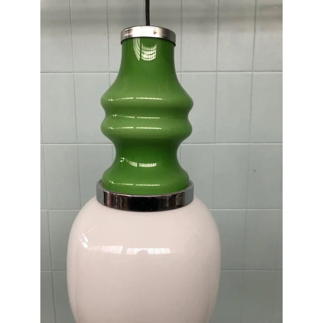 White opal glass chandelier and green glass. The bands are in chromed steel. Produced in Italy in the 1960s. Up to 250V...