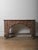 A richly sculpted wooden console defined by its intricate floral relief and strong architectural presence. The piece...