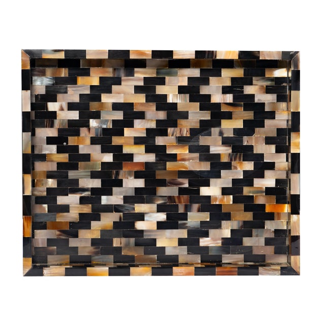 A striking study in artisanal precision, the Aegis Tray features a finely hand-set mosaic of natural horn tiles, each...