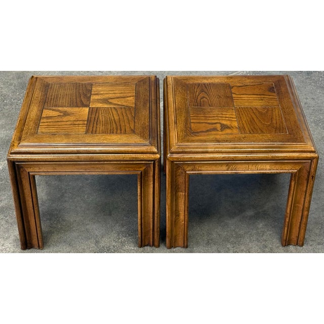 Sleek pair of end tables by Lane circa 1970s. Features a minimalist parsons design crafted in solid oak. Excellent...