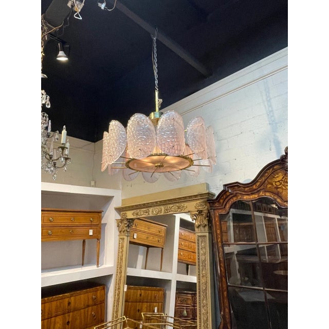 Stylish modern pink Murano glass and brass chandelier. Beautiful pale pink textured glass on a decorative brass base....