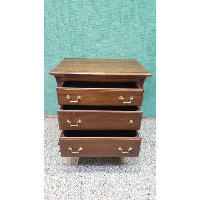 This solid wood nightstand was crafted by Waterford Furniture Makers. It features 3 dovetailed drawers and blocked feet....