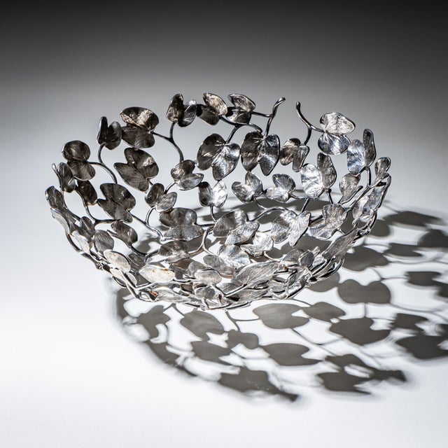 Large open-work bowl in silver-plated brass in the form of stylized leaves of the Kachnar tree (Bauhinia variegata)....