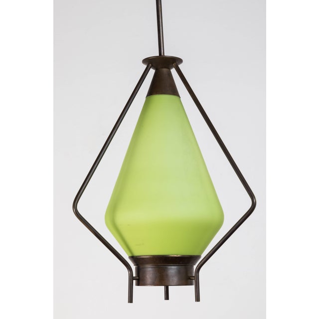Mid-century green glass and brass pendant.