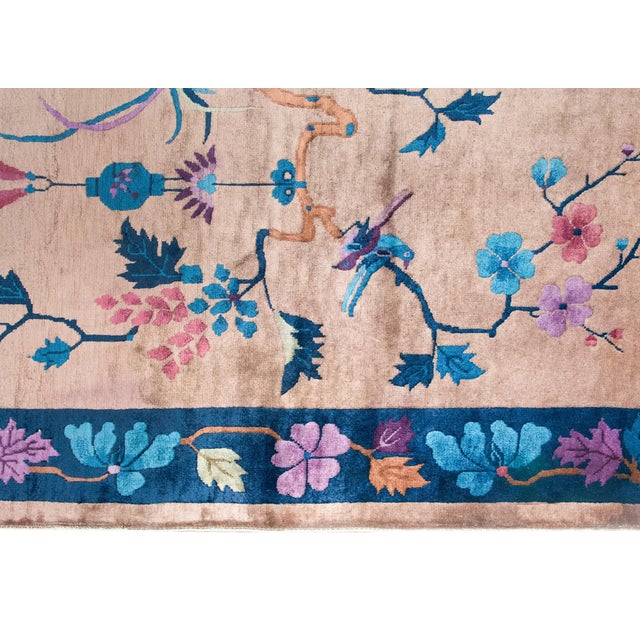 An early 20th-century Chinese Art Deco rug, beautifully woven with a lyrical and symbolic design. At its center, a...