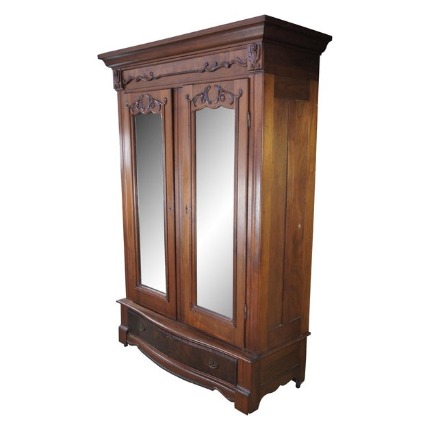 Antique 19th-century French clothing armoire. Made of walnut featuring hand-carved floral / acanthus / beaded details,...