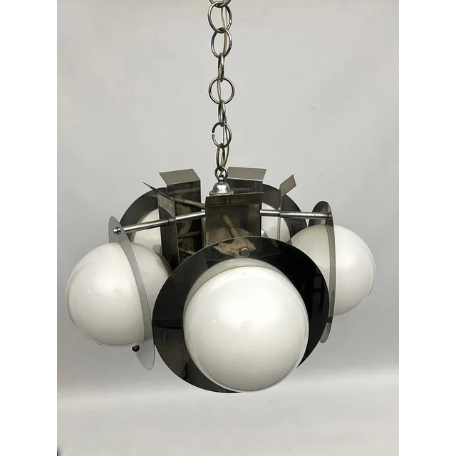 Good vintage condition with normal trace of age and use for this chandelier made from chrome and white glasses. Slight...