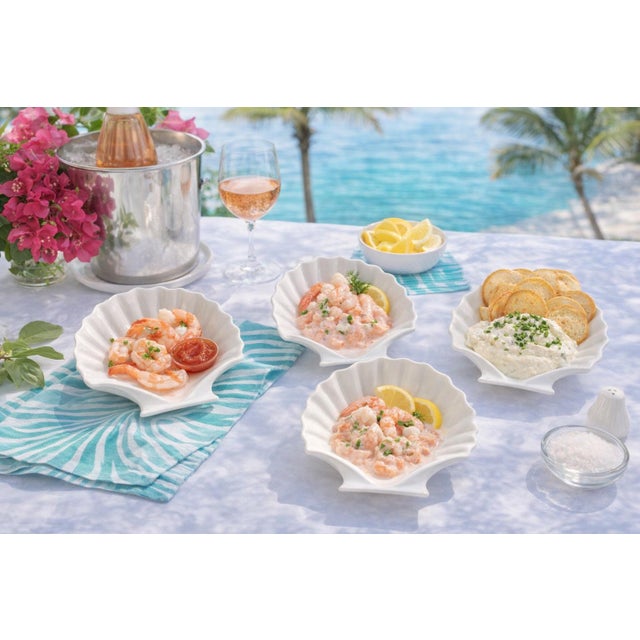 Bring a touch of coastal charm to your table with this set of four ceramic clam shell dishes, each beautifully sculpted...