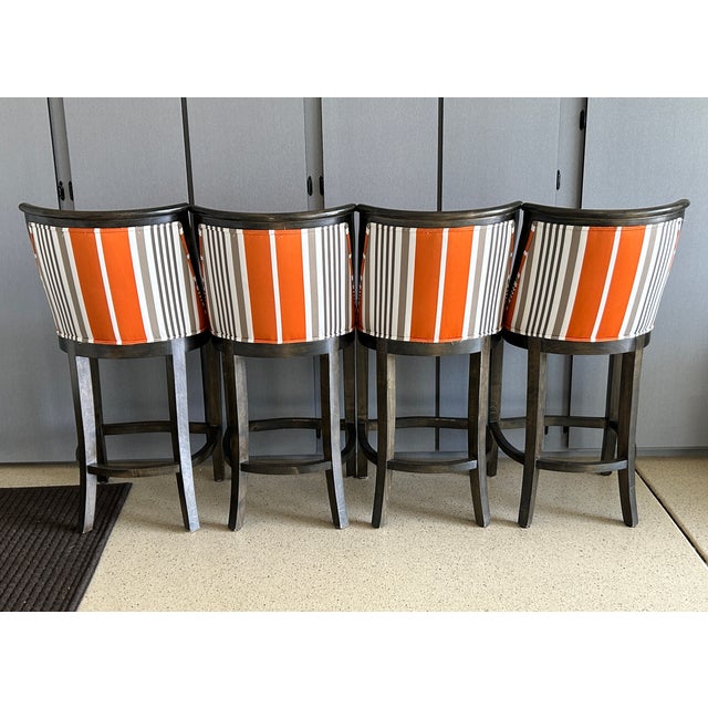 Set of four high-quality Kreiss Thames barstools with sturdy dark wood frames and bold striped upholstery. Comfortable...