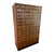 A substantial vintage library card catalog featuring 72 wooden drawers, brass-toned label holders and pulls, and two...