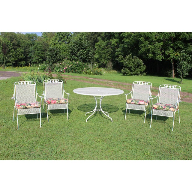 The latest addition to my collection of wrought iron patio furniture is this vintage table and four armchairs with dogwood...