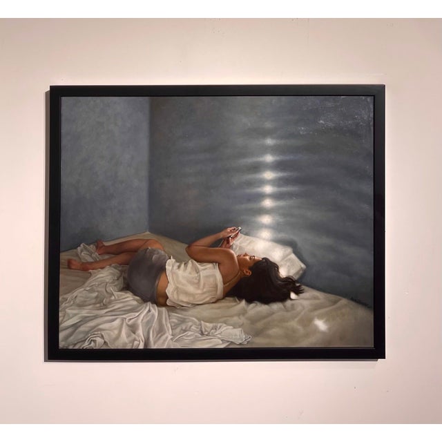 This oil on canvas piece captures a solitary figure reclining on a bed, enveloped in soft, natural light that highlights...