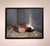 This oil on canvas piece captures a solitary figure reclining on a bed, enveloped in soft, natural light that highlights...