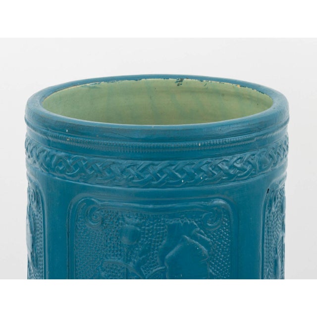 Arts and Crafts Style Floral Motif Umbrella Stand, teal blue painted ceramic, decorated with vignettes of flowers. 21.75"...