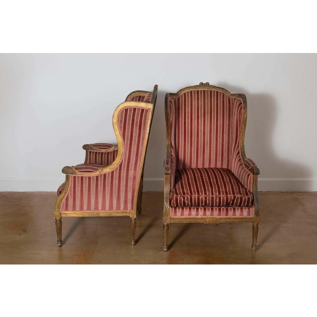 This pair of 19th-century French bergères exudes timeless elegance and embodies the refined craftsmanship of the Louis XVI...