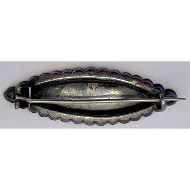 A charming good luck brooch with maker mark WHD and English silver hallmarks. It has a beautiful patina enhancing the...