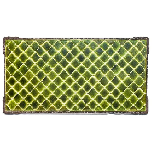 Coffee table in wrought iron and ceramic attributed to Robert Merceris. Hammered base. Plateau made up of a green...