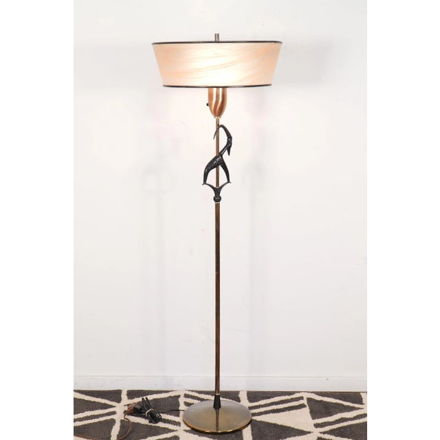 This is a Mid-Century antelope or gazelle floor lamp with the rare original shade, and manufactured by the Rembrandt Lamp...
