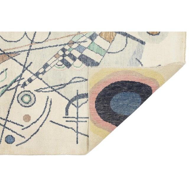 Enhance your space with this 5x8 hand-tufted wool rug, featuring a "Modern Deco" design on a clean ivory background. It...