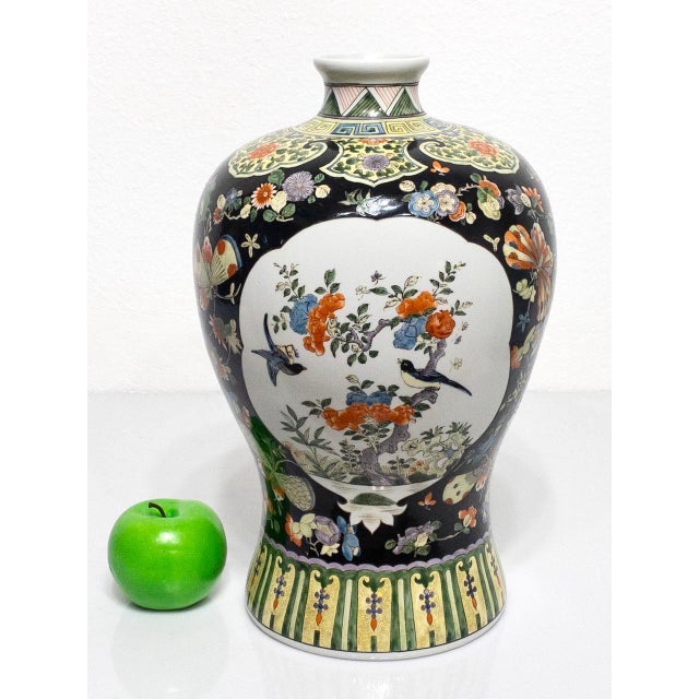 A large Chinese Meiping shaped vase that is finely hand painted in enamels in the Kangxi style. An interesting palette of...