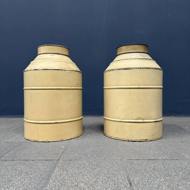 Set of two old Dutch cream-colored storage tins from around 1900. One of the two clicks has a light dent on the side as...