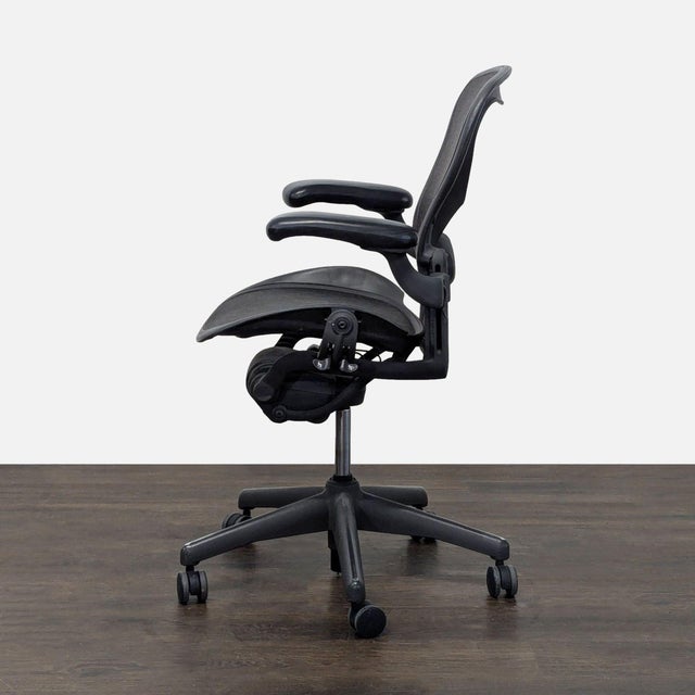This Herman Miller Aeron chair offers top comfort with its breathable black mesh material and fully adjustable arms. The...
