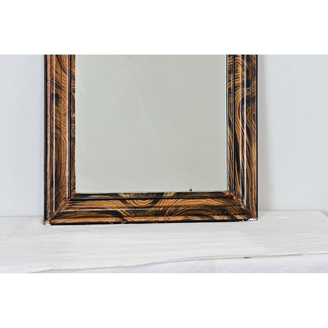 A late 19th century French mirror in that iconic silhouette of the Louis Philippe arched frame, crafted in the Victorian...