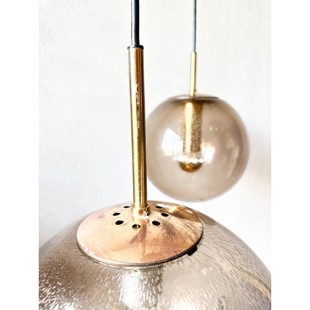 Beautiful mid - Century design. 1970s glass lodge limburg cascade lamp. Plastic gold ceiling plate from which hang 3...