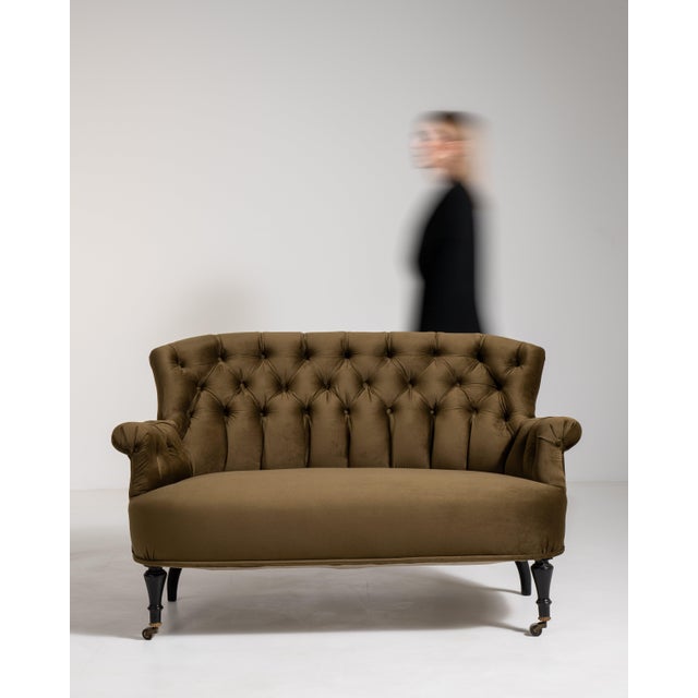 A refined Napoleon III sofa featuring a gently curved silhouette and plush velvet upholstery. Designed for comfort and...