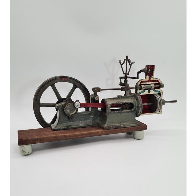 An original metal model of a steam engine, designed for teaching and demonstration purposes, with a visible cylinder...