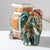 A ceramic decoration from 1960s France in the shape of an elephant. Glazed in celadon hues laced with powder blue and...