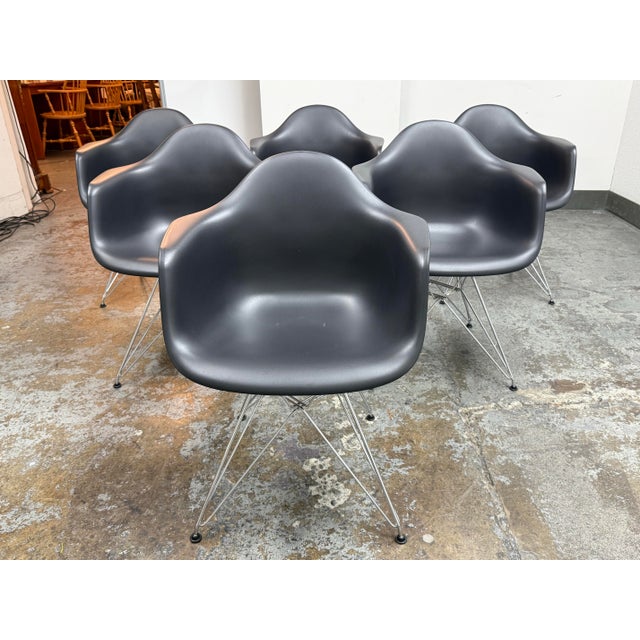 Design Plus Gallery presents a set of six Eames Plastic Armchair DAR Chairs designed by Charles and Ray Eames from Vitra....