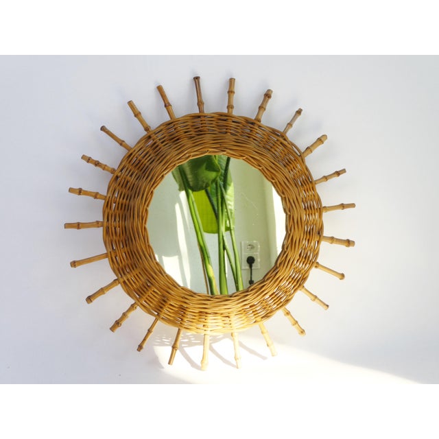 Mid century round mirror made out of rattan and bamboo. The vintage French Riviera style mirror has a shape of a sun. Very...