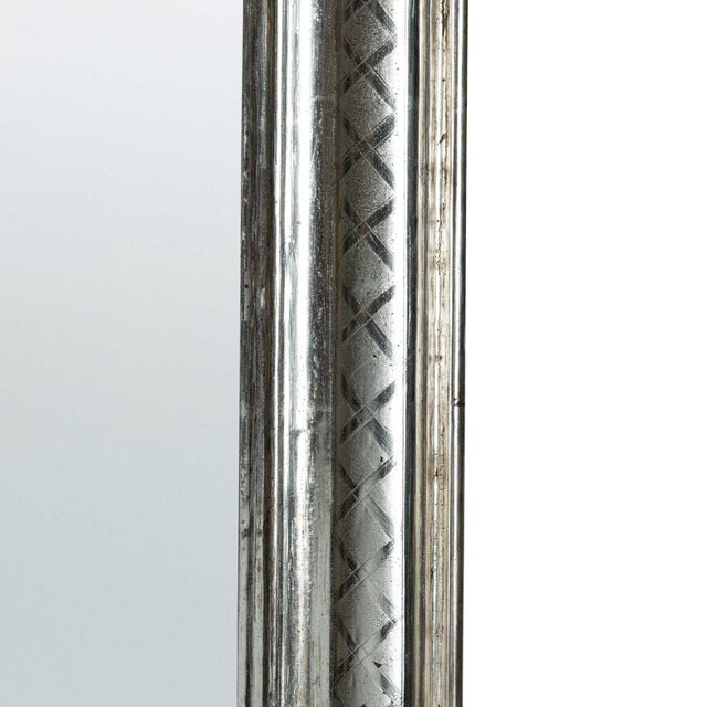 This is a late 19th century monumental silver leaf mirror. The frame has a lovely 'X' pattern that surrounds the mirror. I...