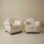 Pair of French Art Deco club chairs, with plush barrel backs and generously rolled armrests. The chairs rest on low,...