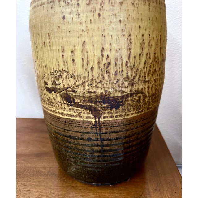 A beautiful Stoneware weed pot. It is unsigned but features a beautiful earthy glaze. Reminiscent of some work we've had...