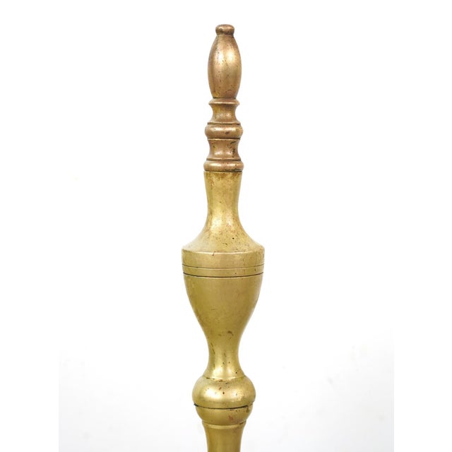 Antique Federal style andirons made of brass with a steeple design. Andirons, also known as firedogs, are metal supports...