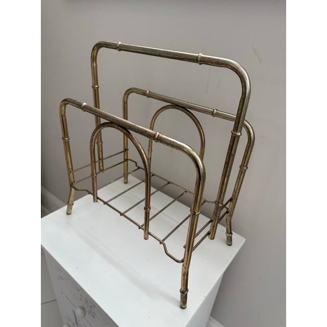 Beautiful vintage brass-tone magazine rack featuring a clean, architectural design with rounded corners and subtle bamboo-...