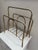 Beautiful vintage brass-tone magazine rack featuring a clean, architectural design with rounded corners and subtle bamboo-...
