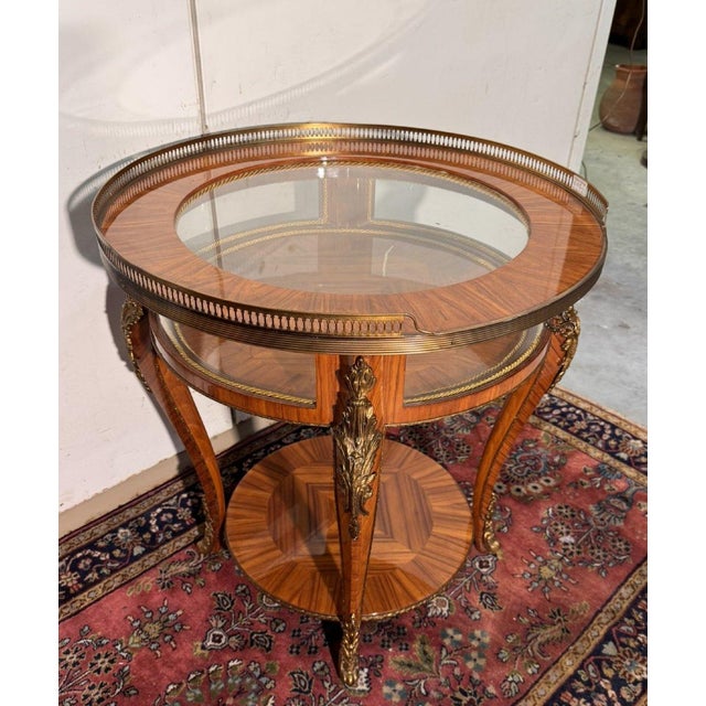 Louis XV style display table in violet wood opens with a circular top encircled by an openwork bronze gallery abundant...