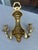 Pair of brass cubist sconces . Each sconce has a double arm .