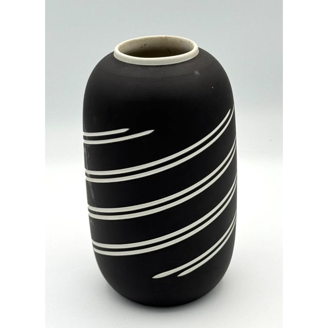 Add sophisticated English elegance to your collection with this **Vintage Wedgwood Black Jasperware Vase**, featuring the...