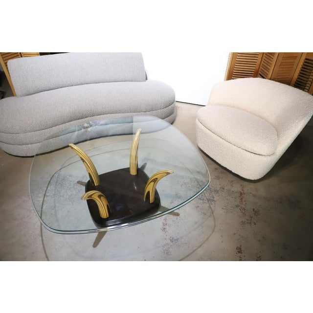 Incredibly handsome Henredon coffee or cocktail table with zebra wood faux tusk base and beveled edge glass top. Table is...