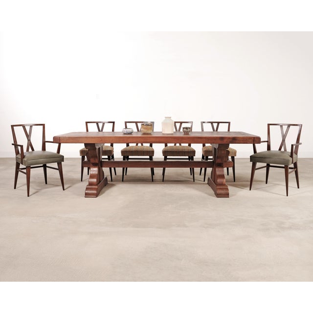 An iconic and rare set of eight mid-century modern dining chairs consisting of six side chairs and two host armchairs...