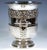 Elegant tulip-shaped silver vessel with a flared opening, resting on a stepped foot with an embossed cord-patterned...