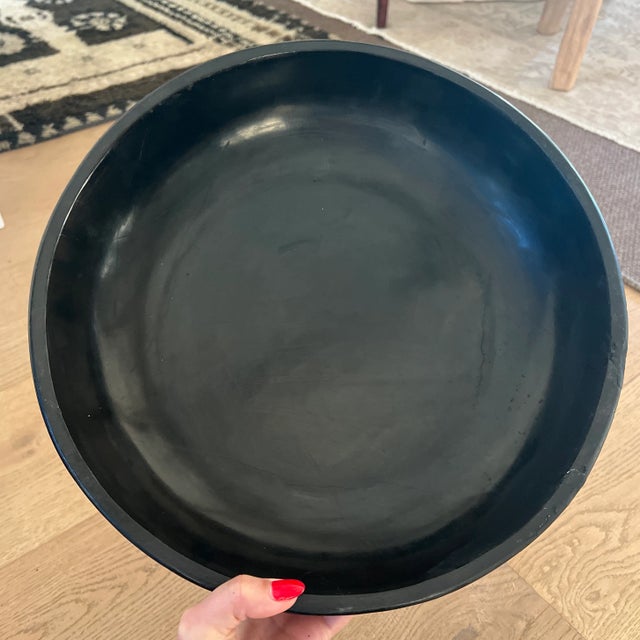 A vintage black lacquered lidded circular box with mother or pearl floral inlaid décor. This vintage Chinese black...